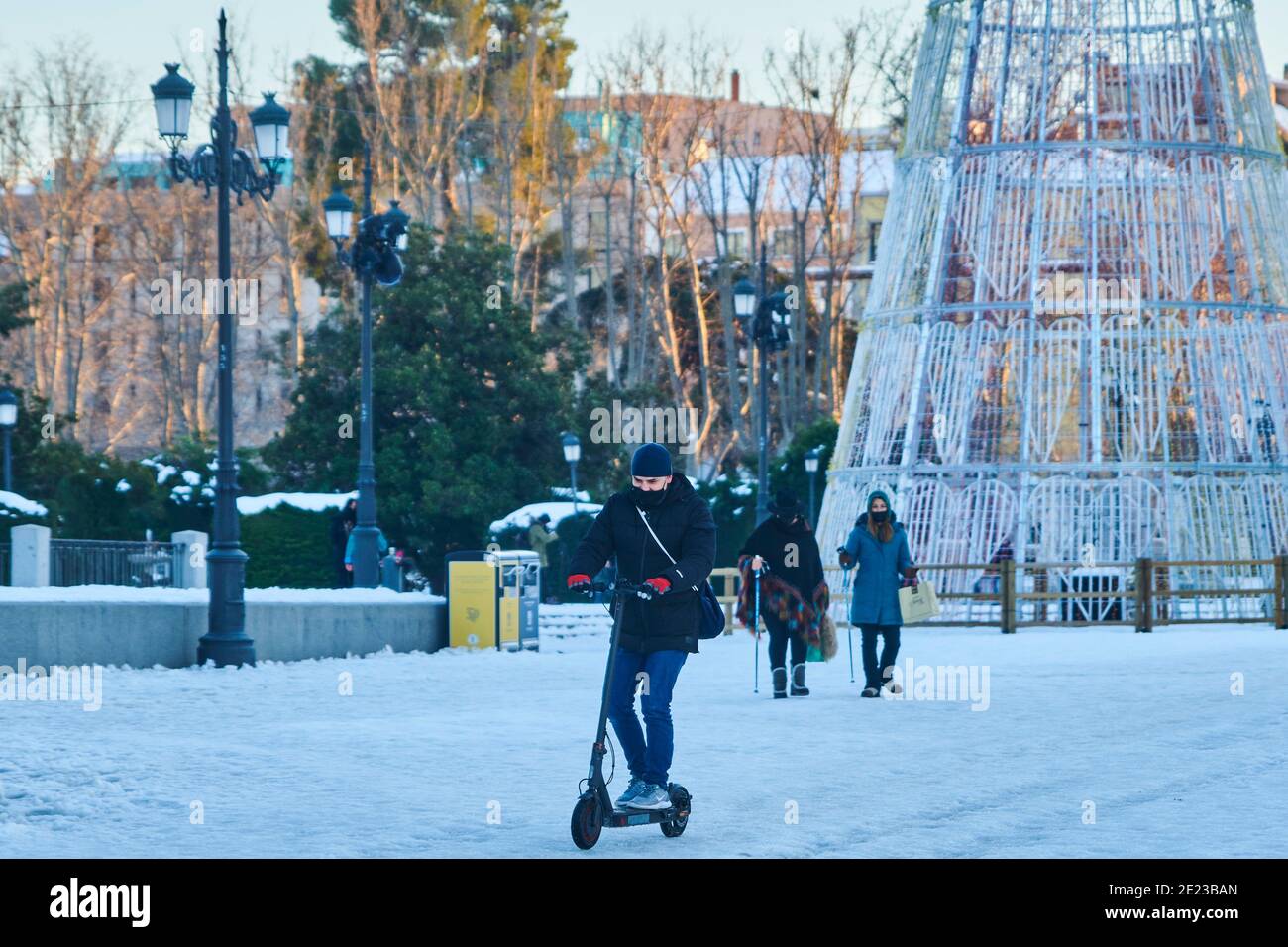 Madrid, Madrid, Spanien. Januar 2021. Mann mit Roller durch verschneiten Orinte-Platz am 11. Januar 2021 in Madrid, Spanien. Storm Filomena brachte mehr als 50 cm Schnee in die spanische Hauptstadt, der meiste seit Jahrzehnten. Kredit: Jack Abuin/ZUMA Wire/Alamy Live Nachrichten Stockfoto