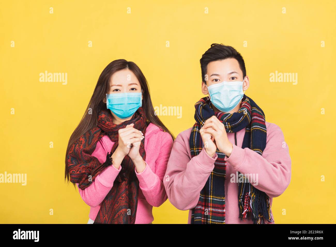 Glücklich asiatische junge Paar in Gesichtsmaske und feiern für chinesische Neujahr. Stockfoto