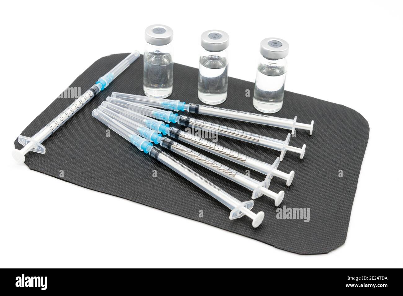Medizinische Spritzen und Nadeln für die Injektion von Hypodermiken auf einer Arbeitsplatte aus Marmor. Spritze und Nadel sind verschlossen. Stockfoto