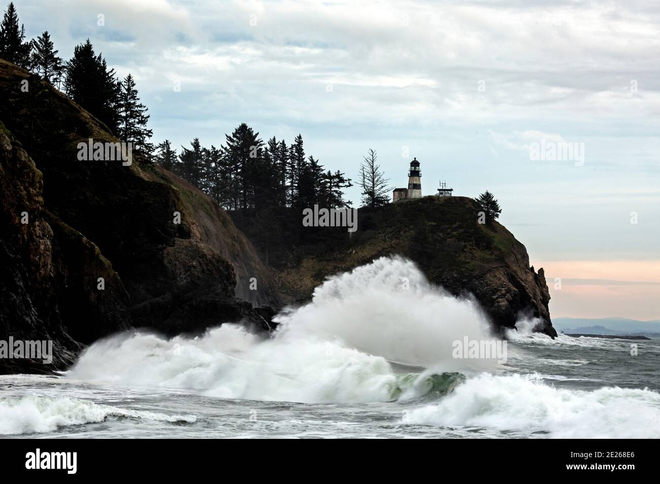 WA19100-00...WASHINGTON - Wellen schlagen in Klippen am Columbia River Abfluss unter Cape Disappointment Lighthouse in Cape Disappointment State P Stockfoto