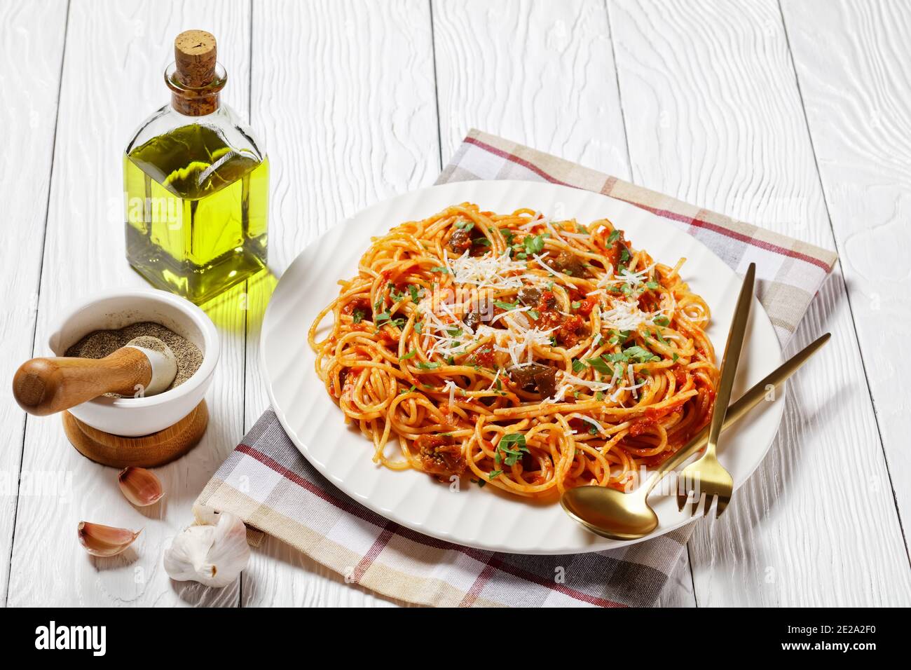 Traditionelle sizilianische Pasta Gericht aus sautierten Auberginen mit Tomatensauce geworfen und gekrönt mit zerfetzten Parmesan serviert auf einem weißen Teller, italienische Küche Stockfoto