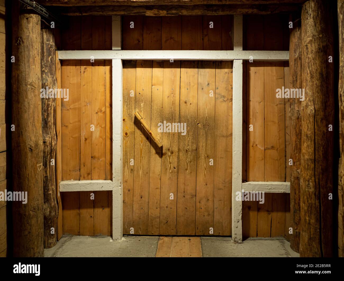 Holzkorridor mit Tür in den Salzbergbauhöhlen. Stockfoto