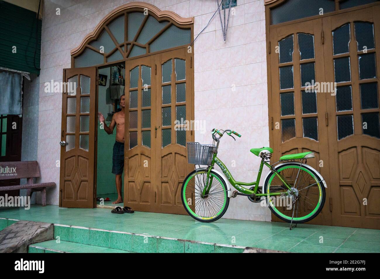 Mann, der vor seinem Haus, Phuoc Hoi, Vietnam, guckt Stockfoto