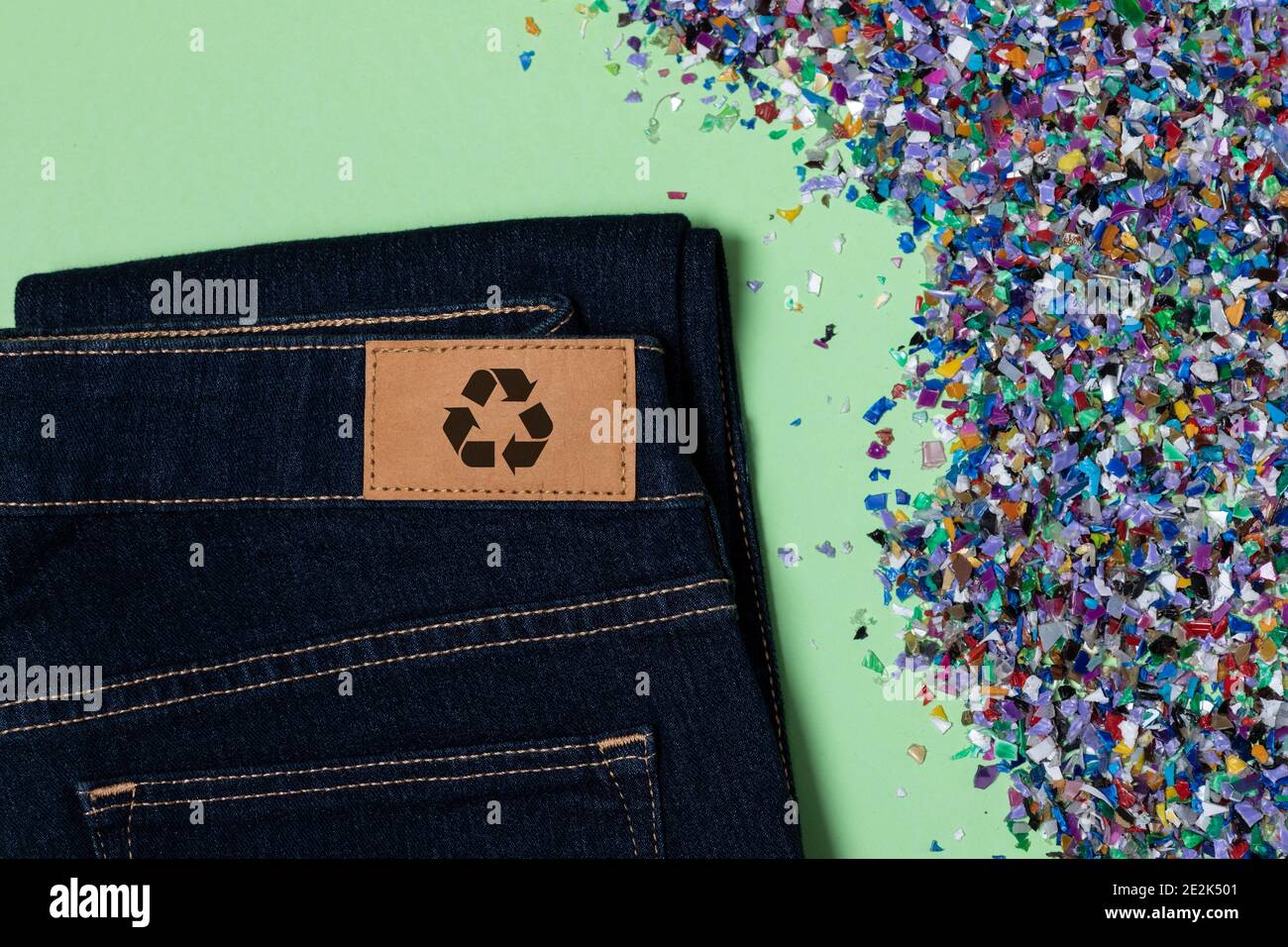 Recycelte blaue Jeans mit einem Bekleidungslabel. Kreislaufwirtschaftsprinzip, Zero Waste Konzept. Wiederverwendung von Materialien und Reduzierung von Abfall in der Mode. Textil ma Stockfoto