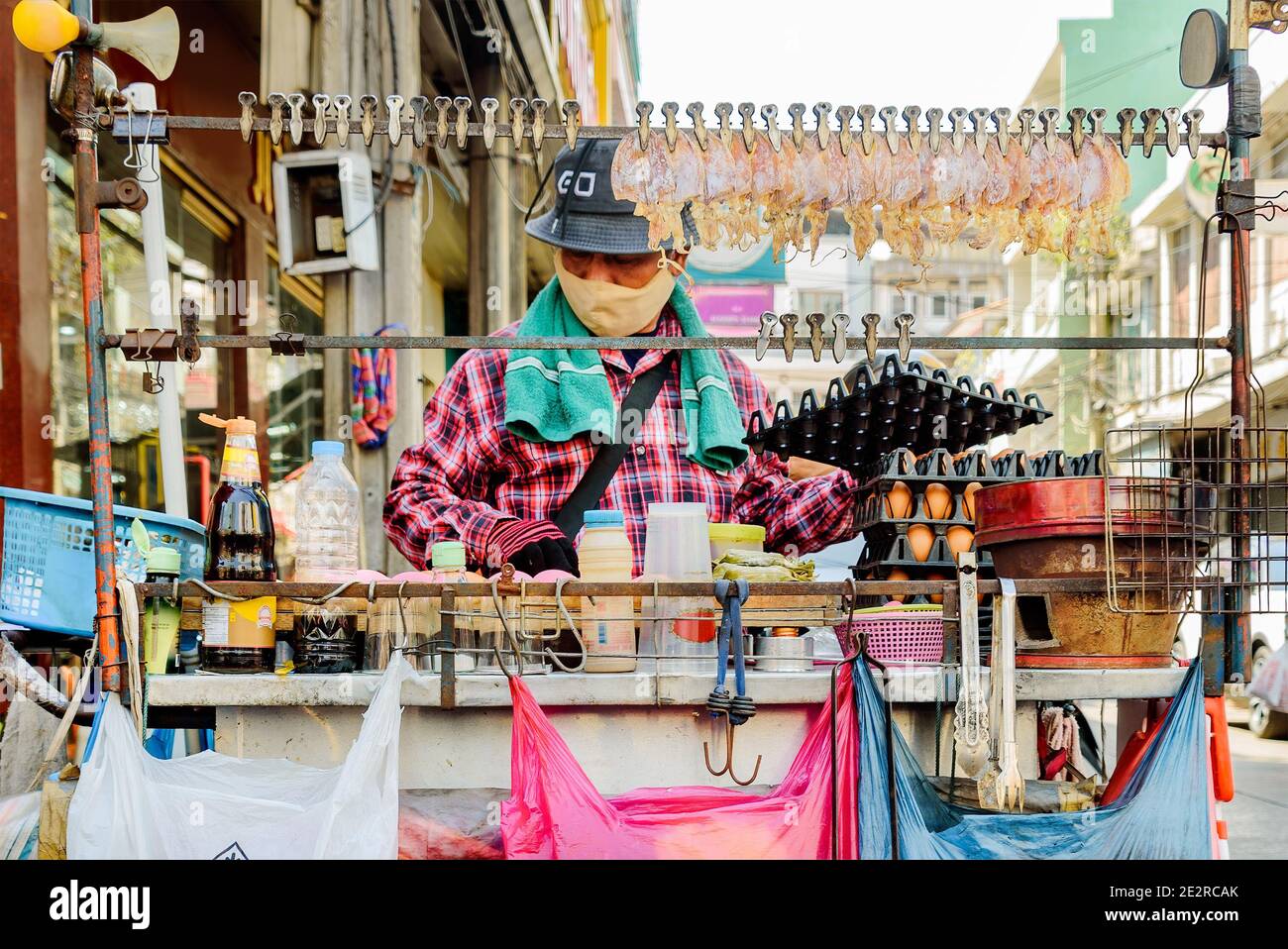 China Town, Bangkok, Thailand - 14. Nov. 2020: Ein Street Food Verkäufer muss immer eine schützende Gesichtsmaske tragen, während er sein Essen verkauft. Stockfoto