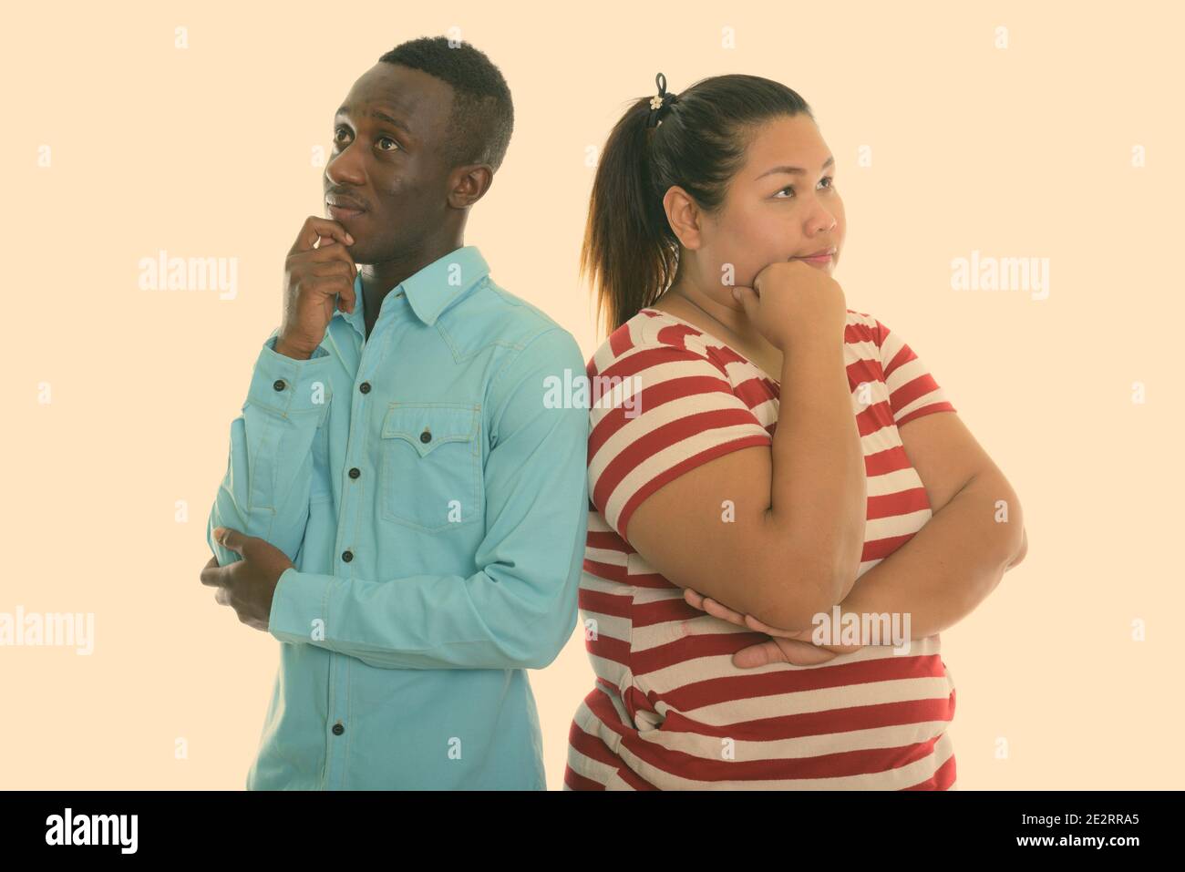 Junge Fett asiatische Frau und Jungen schwarzen afrikanischen Mann denken, während Sie zusammen auf der Suche Stockfoto
