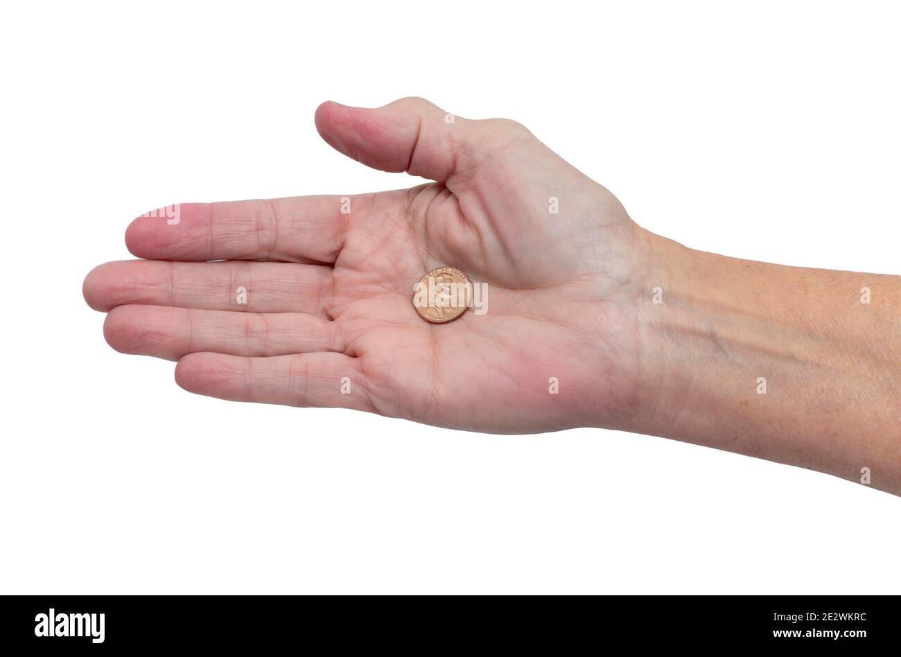 Horizontale Aufnahme einer rechten Handfläche mit einem einzigen Penny während der Pandemie. Stockfoto