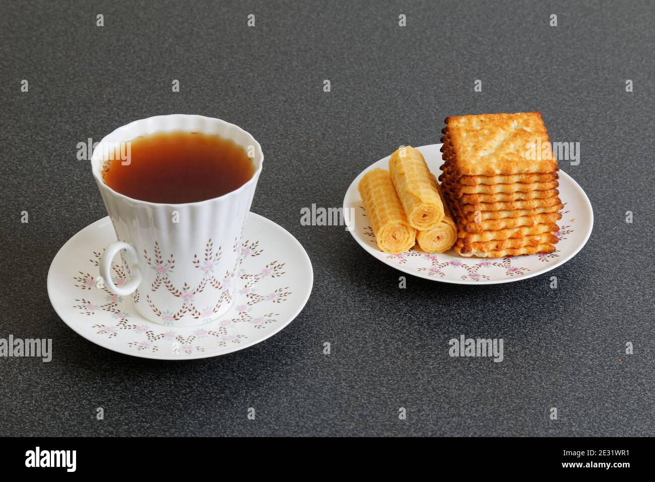Kekse und eine Tasse porzellan-Tee auf dem dunklen Tisch Stockfoto
