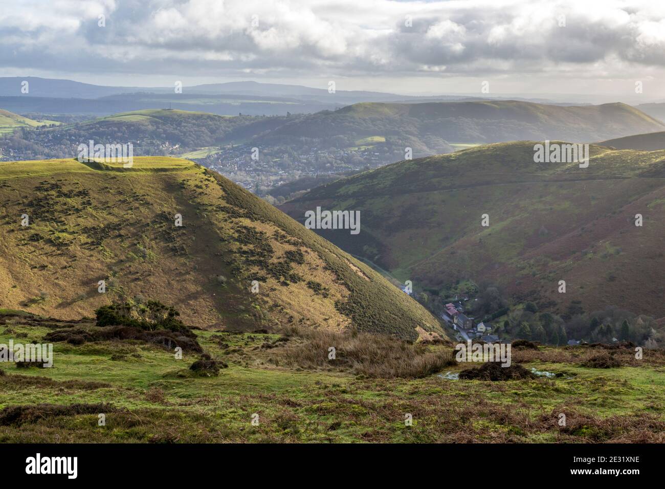 Bodbury Ring Iron Age Hill Fort auf dem Long Mynd, Shropshire, England. Die Stadt der Kirche Stretton dahinter. Carding Mill Valley unten rechts. Stockfoto