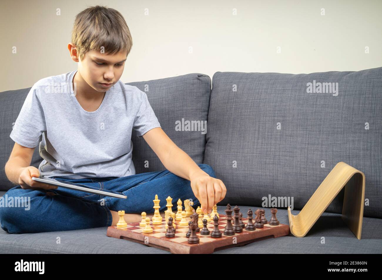 Teenager Junge lernen, Schach online mit Tablet-Computer zu spielen