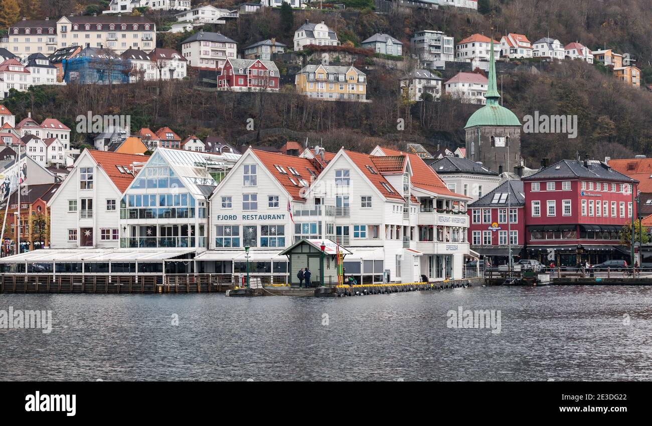 Bergen, Norwegen - 17. November 2017: Küstenstadtbild des Hafens von Bergen. Fassade des Fjord Restaurants. Normale Leute sind auf der Straße Stockfoto