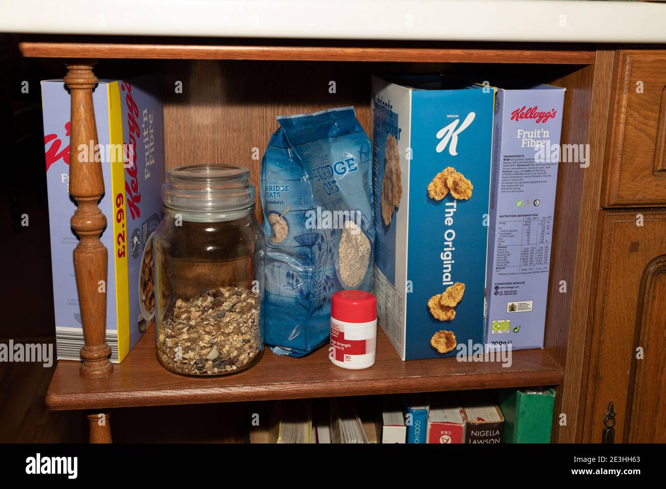 Eine Reihe Frühstückscerealien plus eine Flasche Vitamin D Pillen auf einem Regal in einer heimischen Küche in Oldham, Großbritannien. Stockfoto