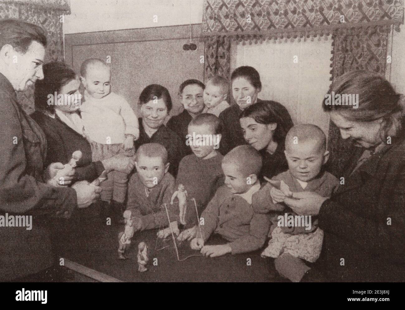 Arbeiter des Werkes Krasny Bogatyr mit Adoptivkindern, deren Eltern während des Krieges 1942 starben. Stockfoto