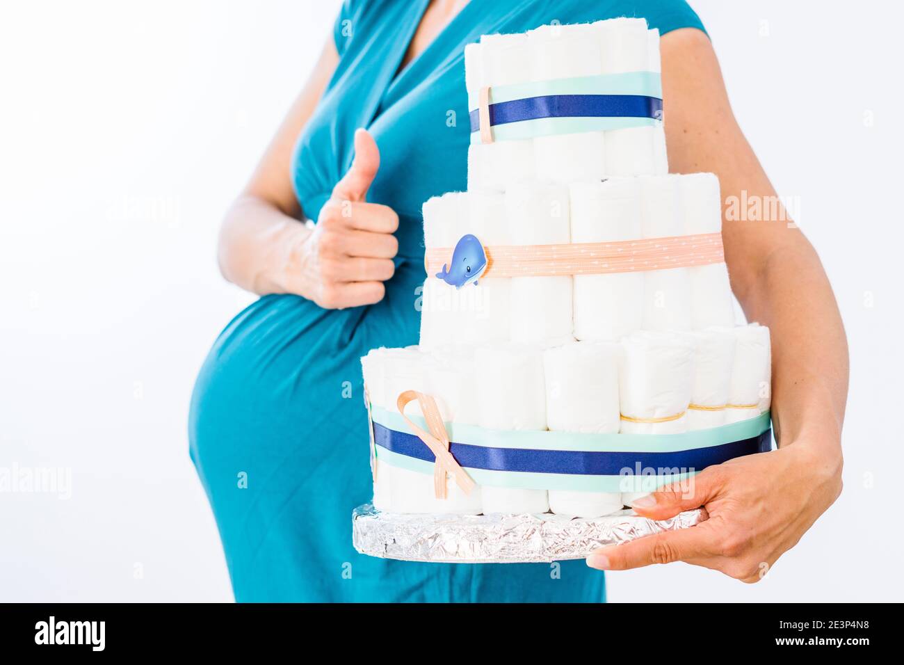 Schwangere Frau hält Windelkuchen für ihren ungeborenen Jungen Stockfoto