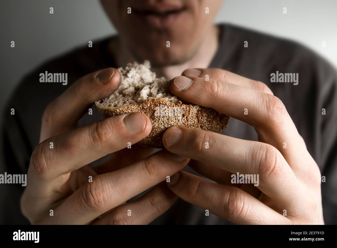 Hunger-Konzept. Brotscheiben in den Händen eines Mannes. Armut. Stockfoto