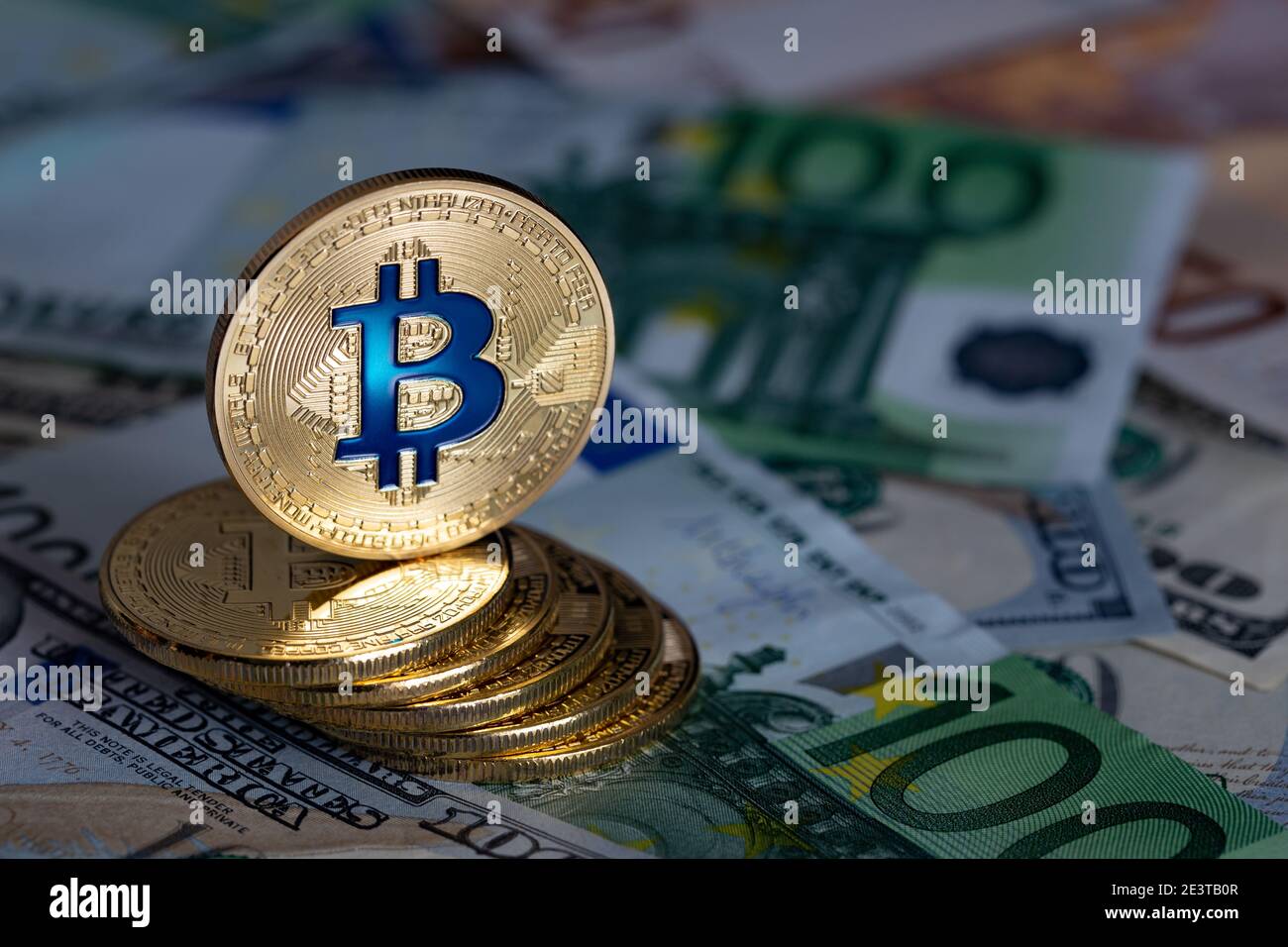 Kryptowährung und elektronische Zahlungen. Bitcoins Nahaufnahme auf dem Hintergrund von Papierrechnungen verschiedener Länder. Stockfoto