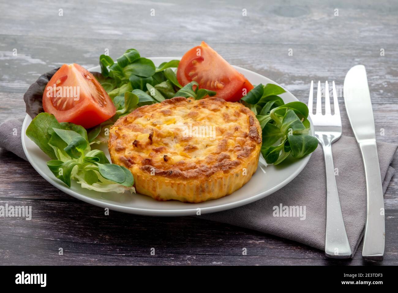Käsefrittata serviert mit einem Salat auf einem weißen Teller Stockfoto