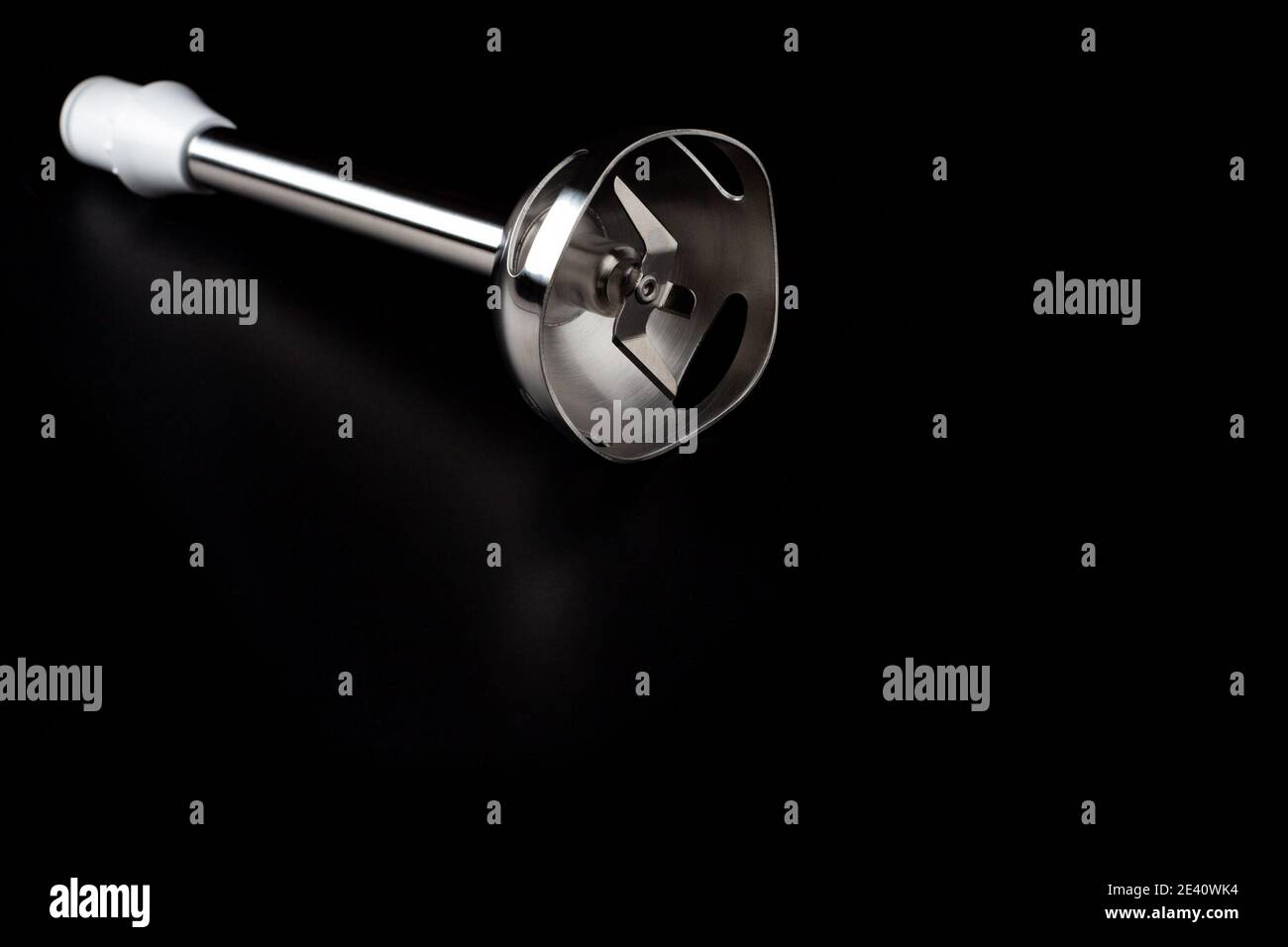 Elektrische Stabmixerdüse mit scharfer Klinge, die auf dem isoliert ist Dunkler Oberflächenhintergrund Stockfoto
