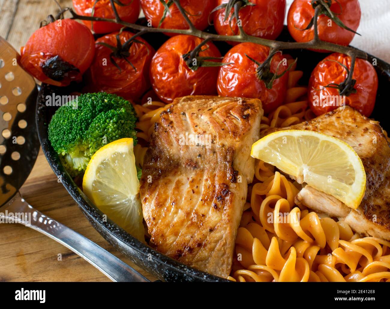 mediterrane Mahlzeit mit Pasta, Fisch und Gemüse Stockfoto