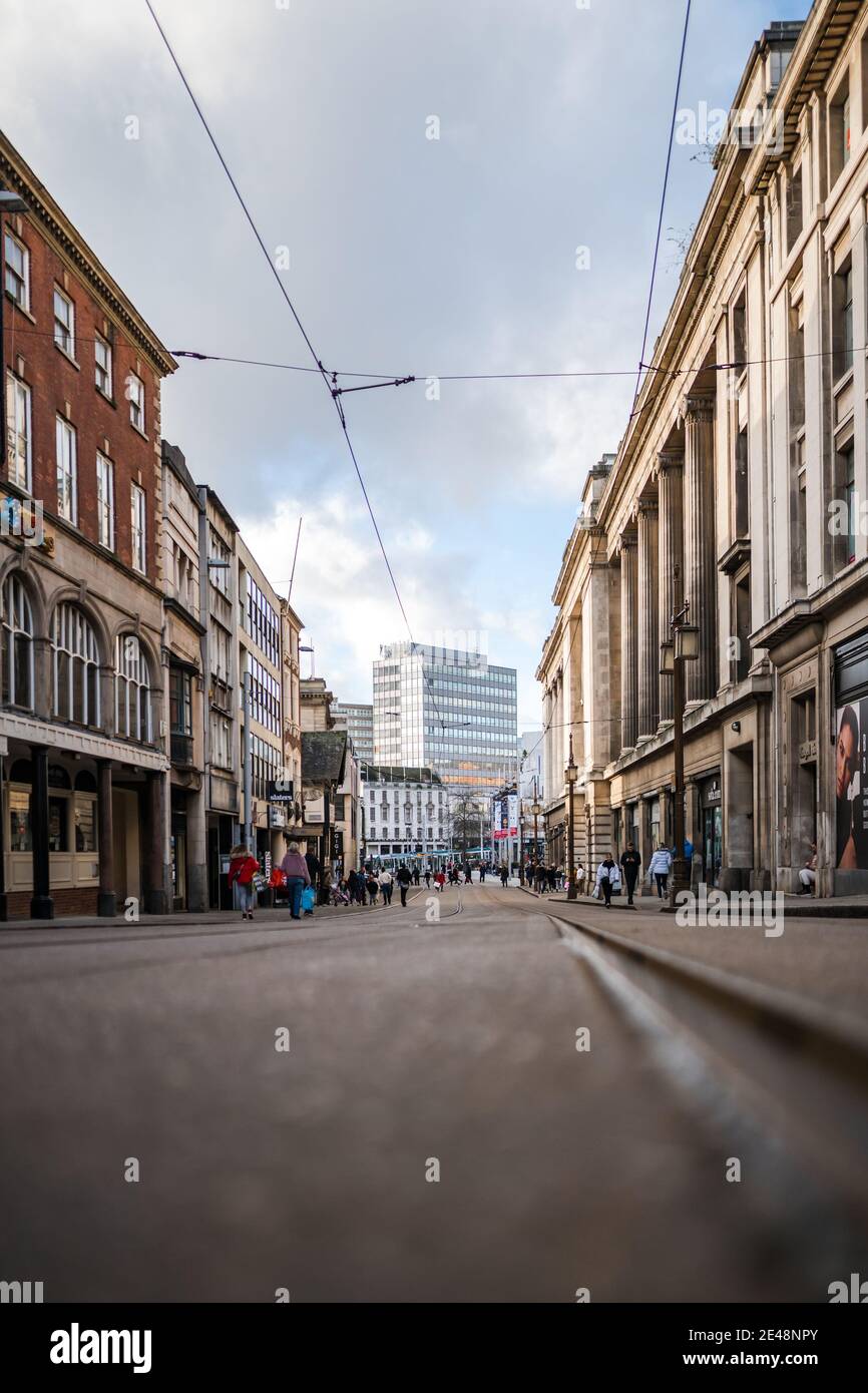 Nottingham City Centre Street scene Bürogebäude in niedrigen Winkeln Und Einzelhandel Käufer während der Aussperrung Pandemie dramatische Sky Shops Einzelhandel Und Büros Stockfoto