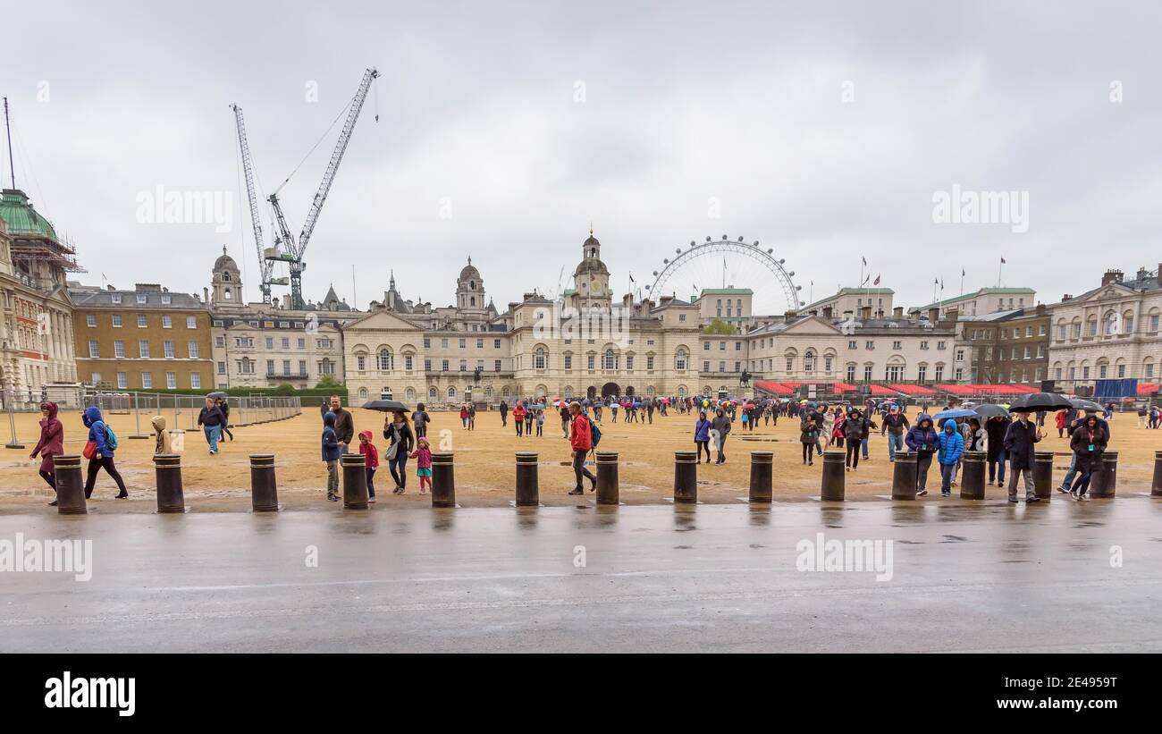 London, Großbritannien - 28. April 2018: Touristen mit Regenschirmen besuchen die Horse Guard Parade im Zentrum von London an regnerischen Tagen Stockfoto