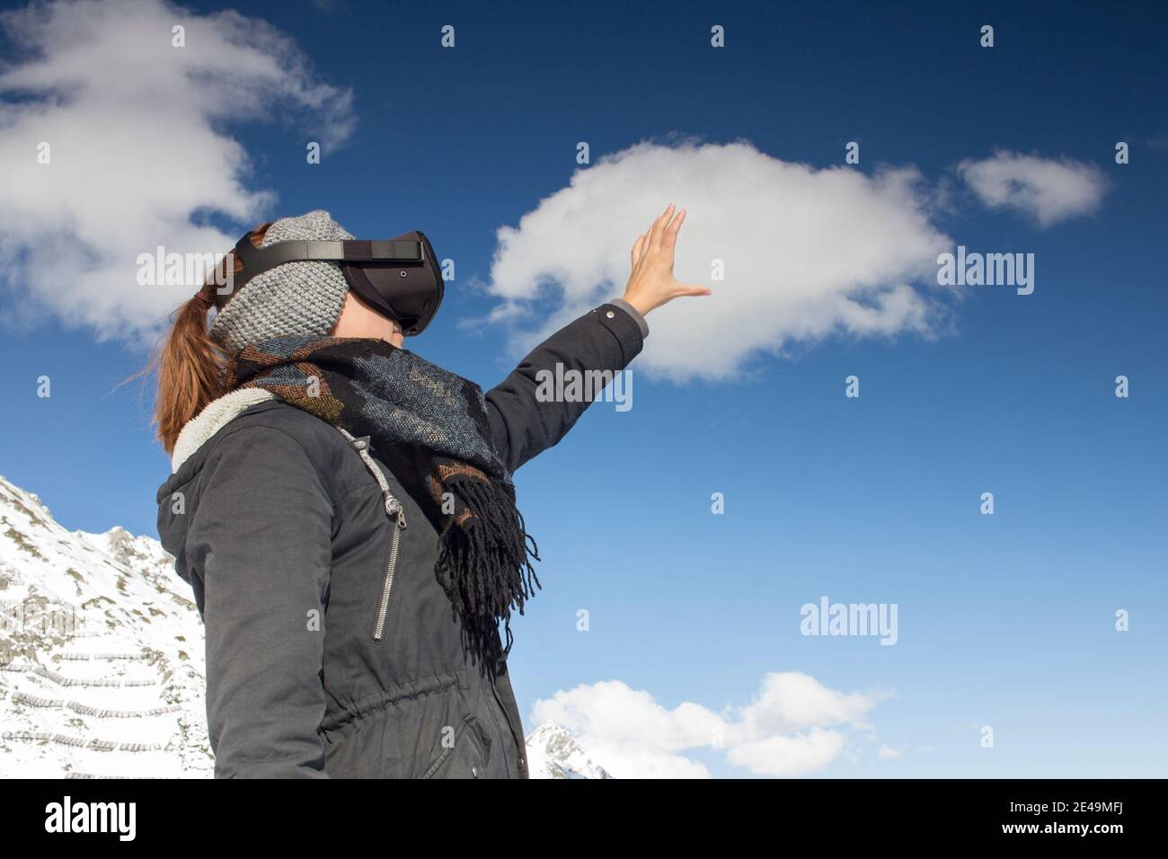 Person mit Virtual-Reality-Brille vor Bergkulisse Stockfoto