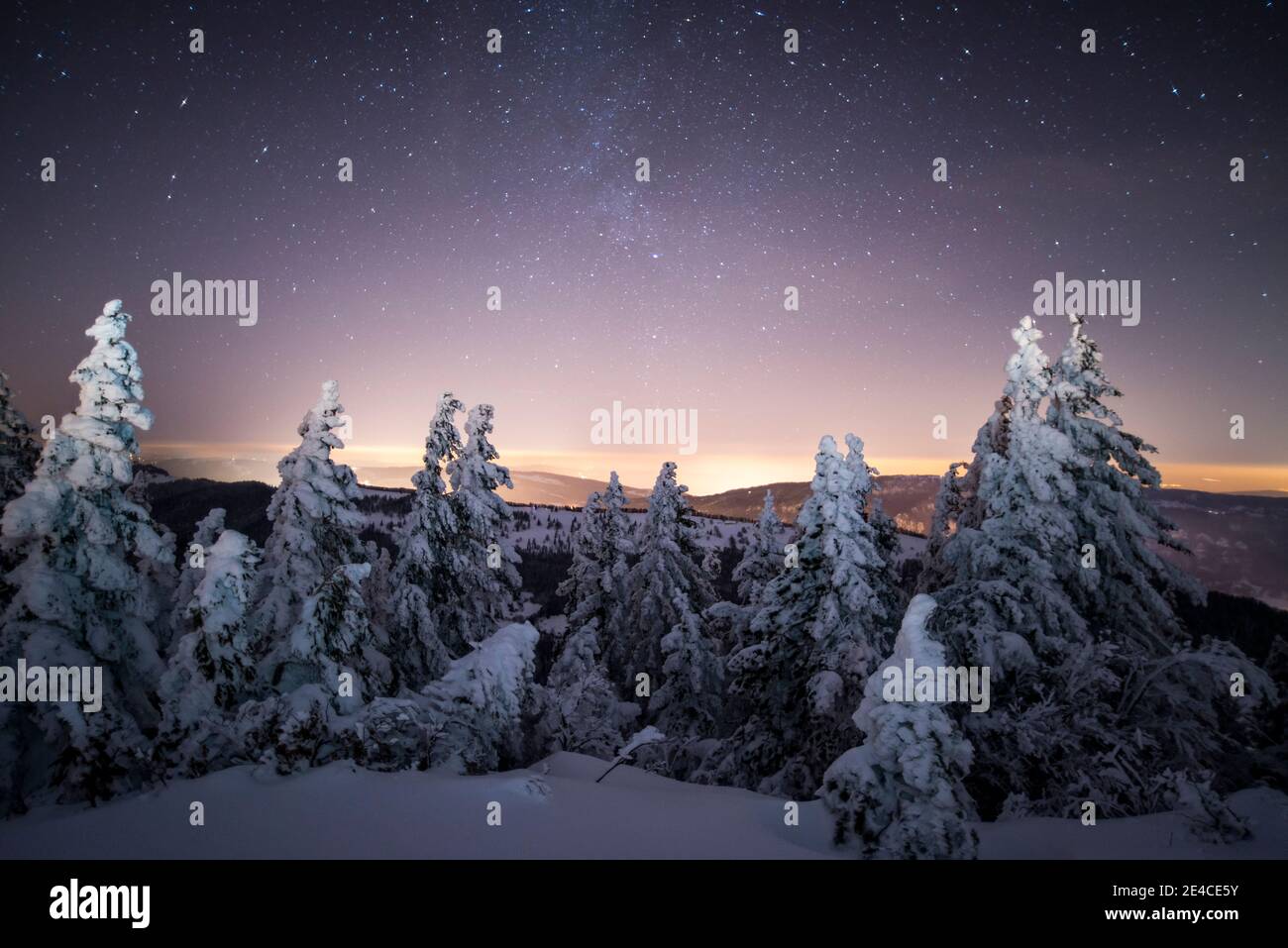 Weihnachtsstimmung, nachts unter den Sternen auf dem frisch verschneiten Berg Stockfoto