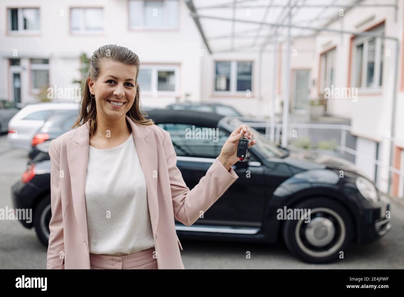 Porträt einer lächelnden Geschäftsfrau mit Autoschlüssel Stockfoto