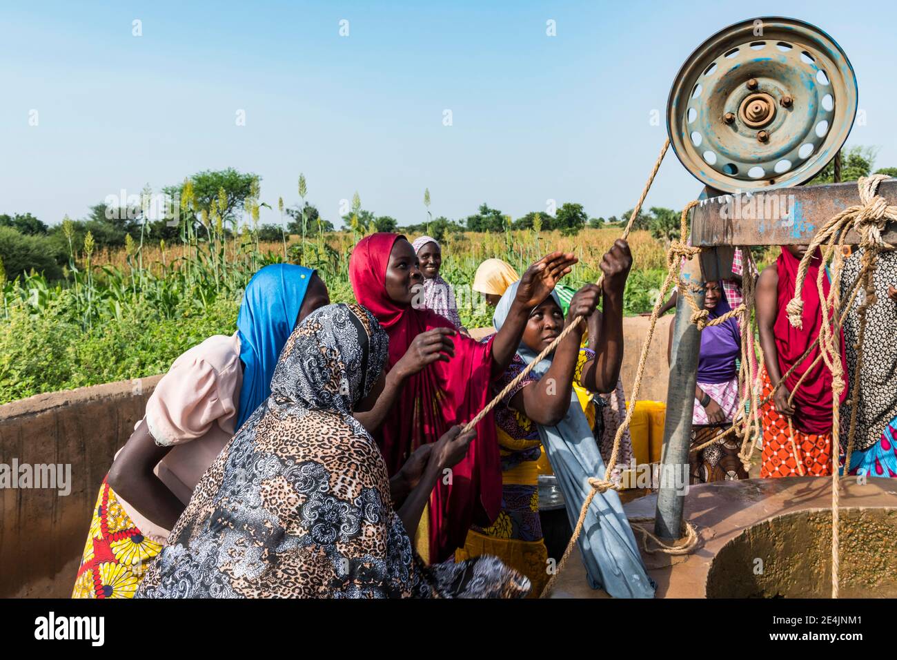 Bunt gekleidete Frauen holen Wasser am Brunnen, Dogondoutchi, Niger Stockfoto