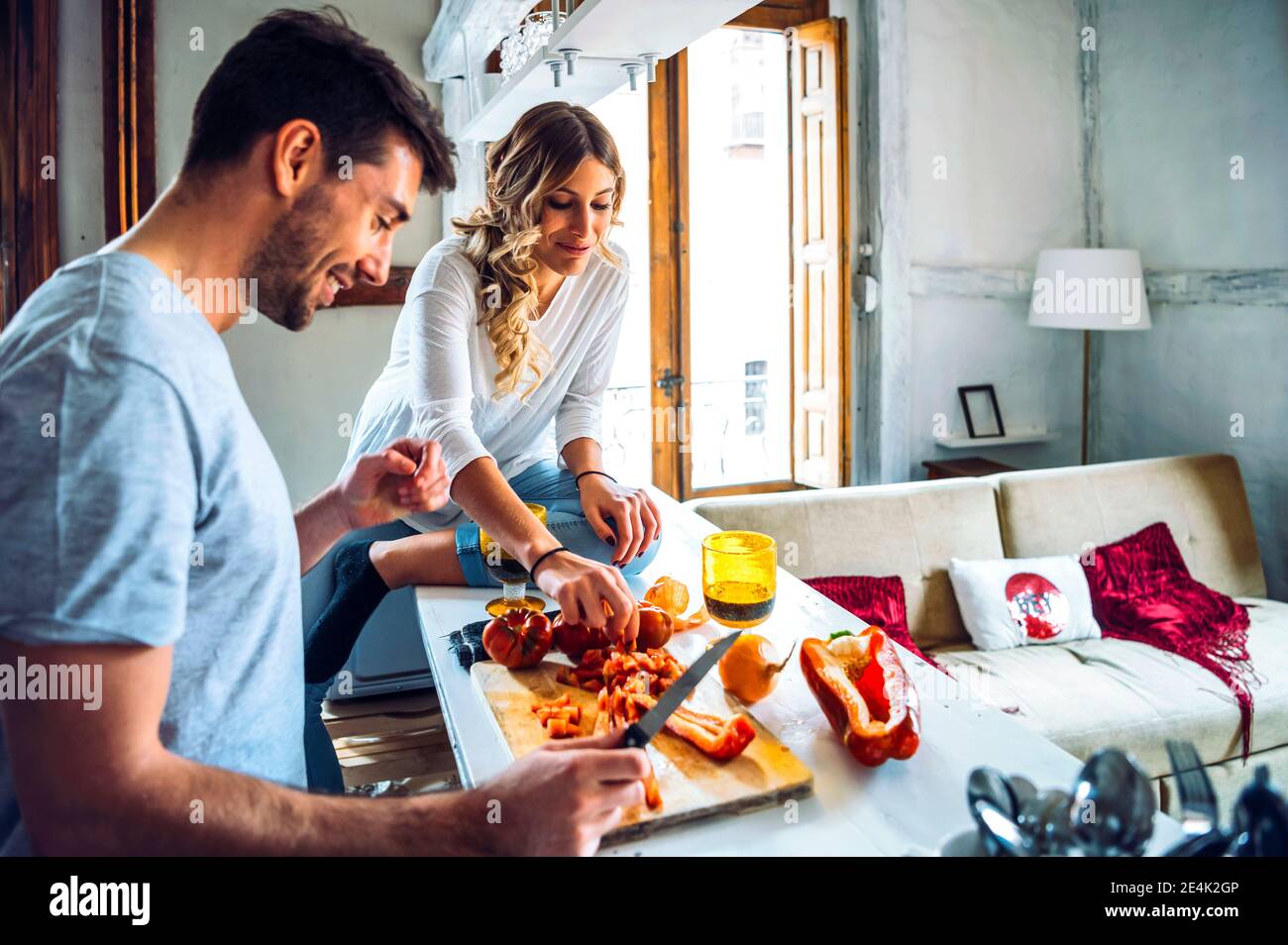 Junger Mann bereitet Essen mit Freundin zu Hause Stockfoto