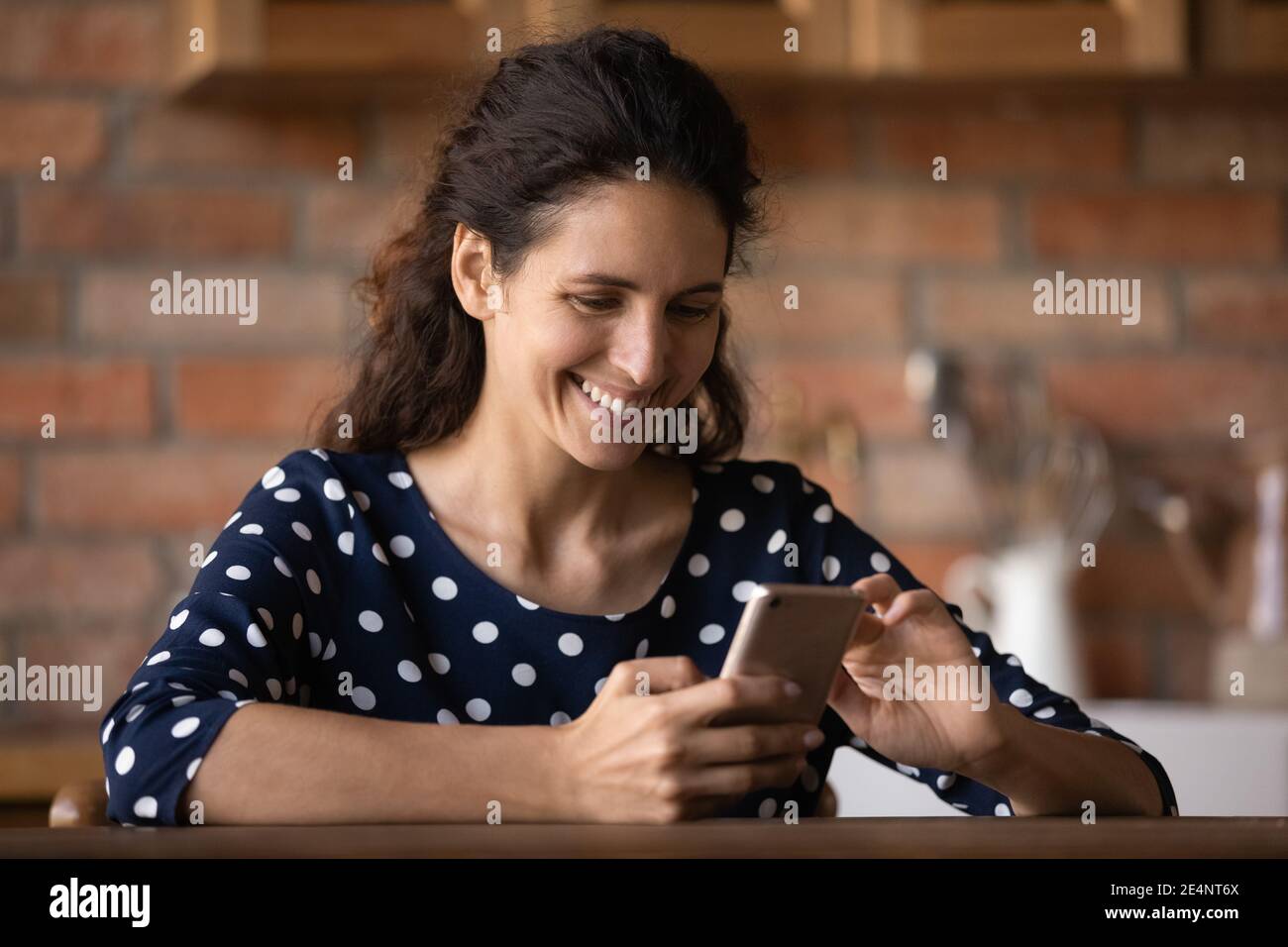 Lächelnde Frau Blick auf Handy-Bildschirm SMS online Stockfoto