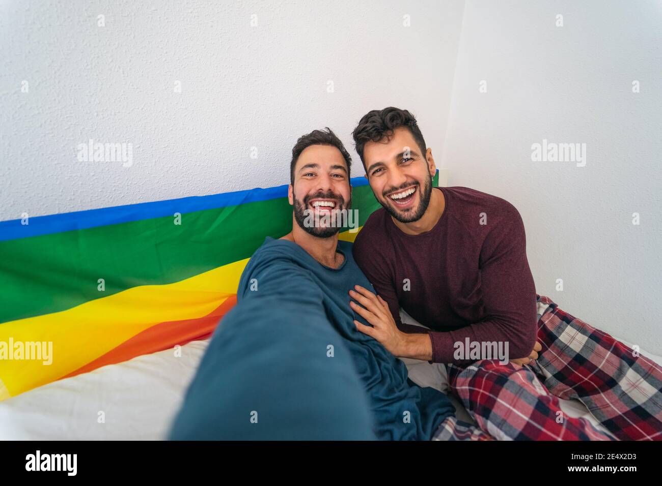 Glücklich Gay paar mit Spaß nehmen Selfie im Bett - Homosexuelle Liebe und Technologie Konzept Stockfoto
