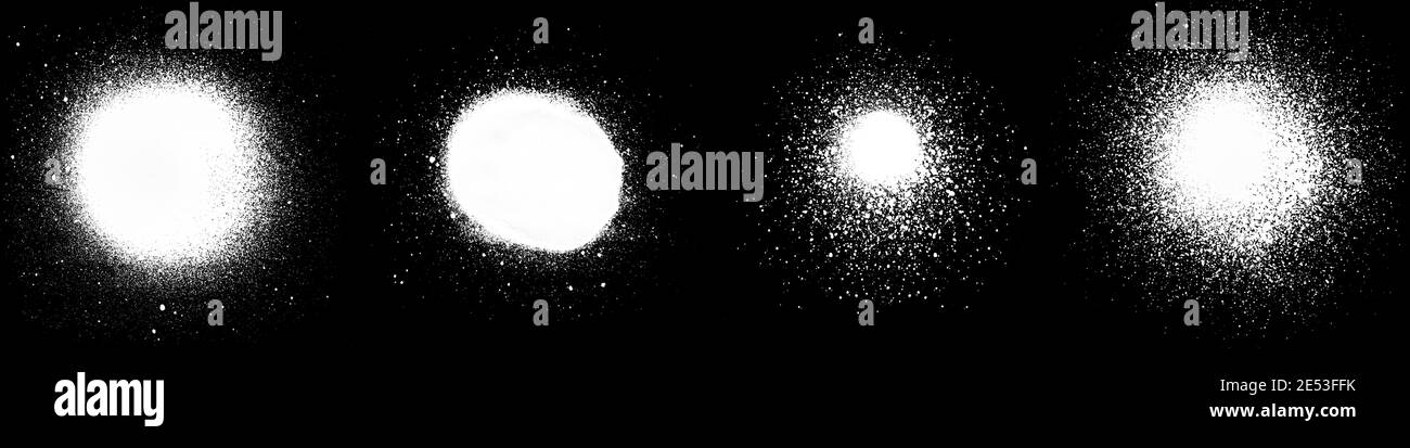 Nahaufnahme mehrerer weißer Sprühflecken und Spritzer, isoliert auf schwarzem Hintergrund. Stockfoto