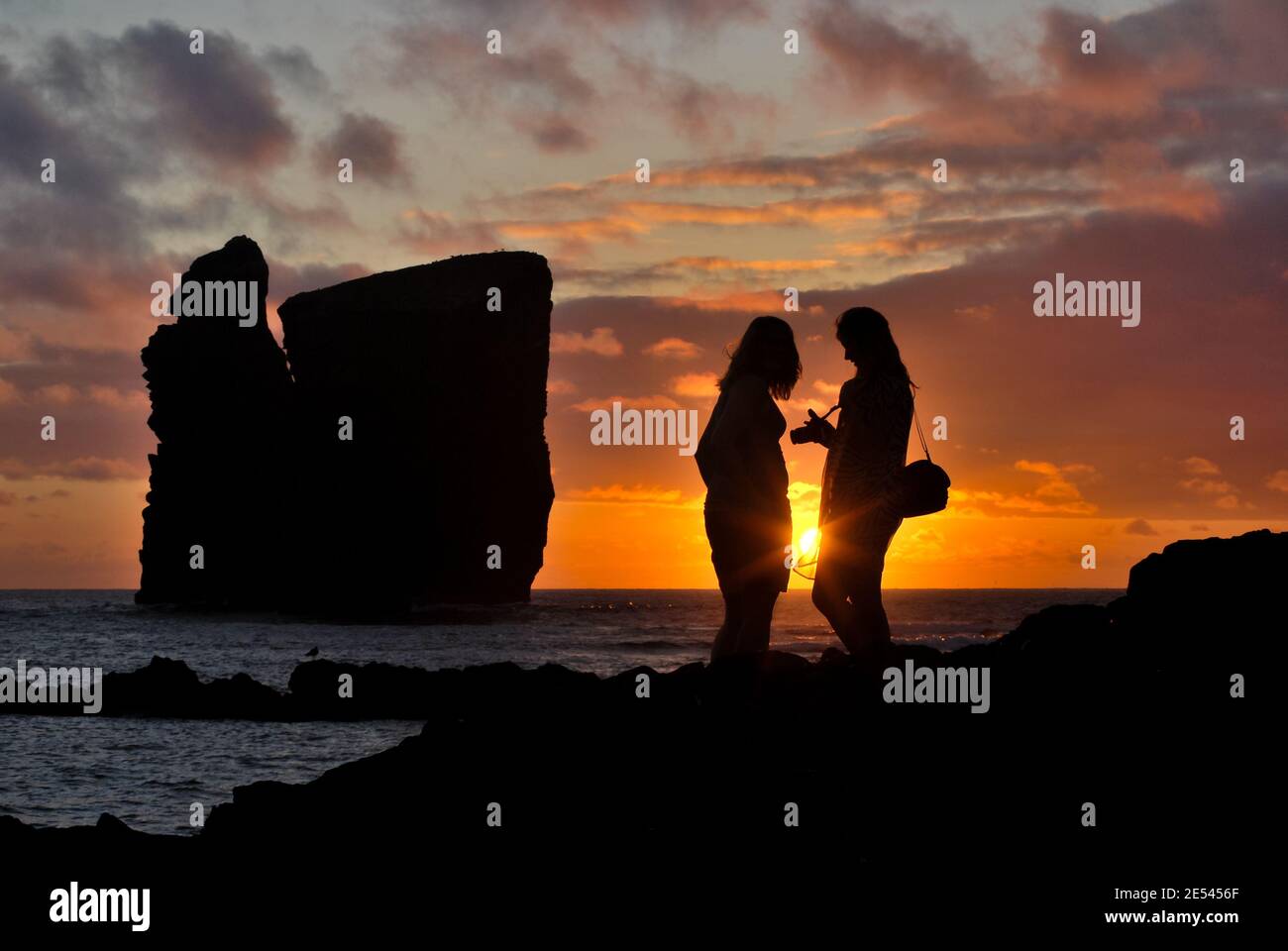 Silhouette von zwei Personen, bei Sonnenuntergang, in Mosteiros, Sao Miguel Insel, Azoren. Stockfoto