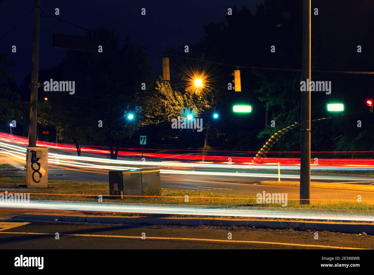 Leichte Spuren von Autoverkehr, Scheinwerfern und Bremsleuchten, entlang der Straßen der Stadt in der Nacht. Stockfoto
