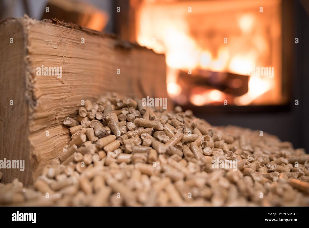 Holzofen Heizung mit im Vordergrund Holzpellets - wirtschaftlich Heizsystemkonzept Stockfoto