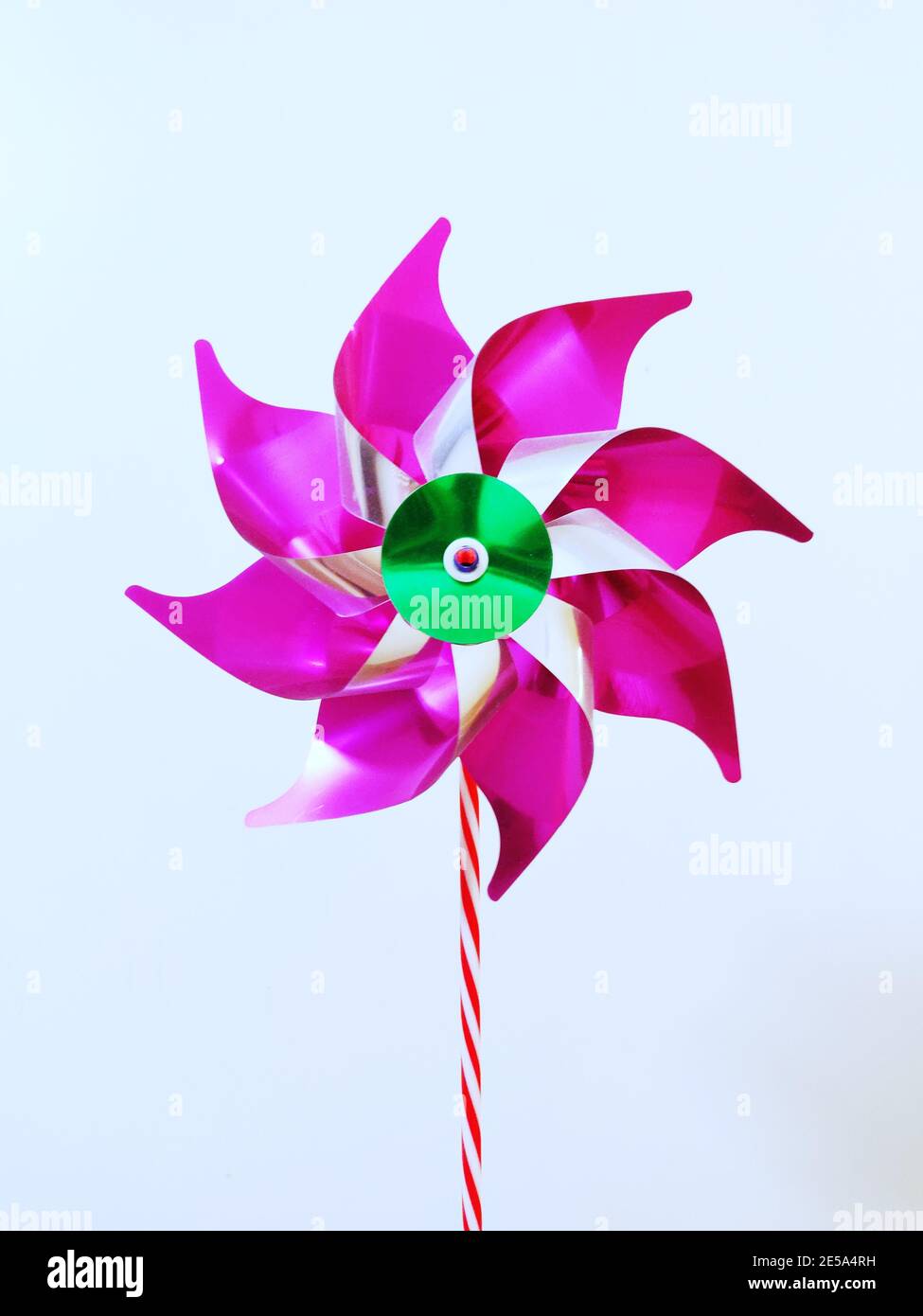 Vertikale Aufnahme eines rosa Windrad isoliert einen weißen Hintergrund Stockfoto