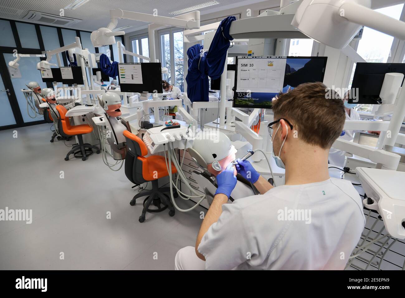 21. Januar 2021, Sachsen, Leipzig: Johann Dörschner, Zahnstudent an der Universität Leipzig, praktiziert an einem "Phantompatienten" neben leeren Nachbarsitzen. Sie können nicht lernen, ein Zahnarzt online zu sein. Deshalb sollte die Ausbildung der 274 Zahnmedizinstudenten 'am Patienten' auch in der Corona-Krise möglich bleiben. Die Laborarbeit wurde verkleinert, die Kurse geviertelt und dann halbiert. Hygienekonzepte werden ständig an die Arbeit an echten Patienten angepasst. Schließlich müssen die angehenden Zahnärzte in der Lage sein, sicher eine Füllung zu machen oder eine Krone vorzubereiten. Foto: Jan Woitas/dpa-Zentralbild/dp Stockfoto