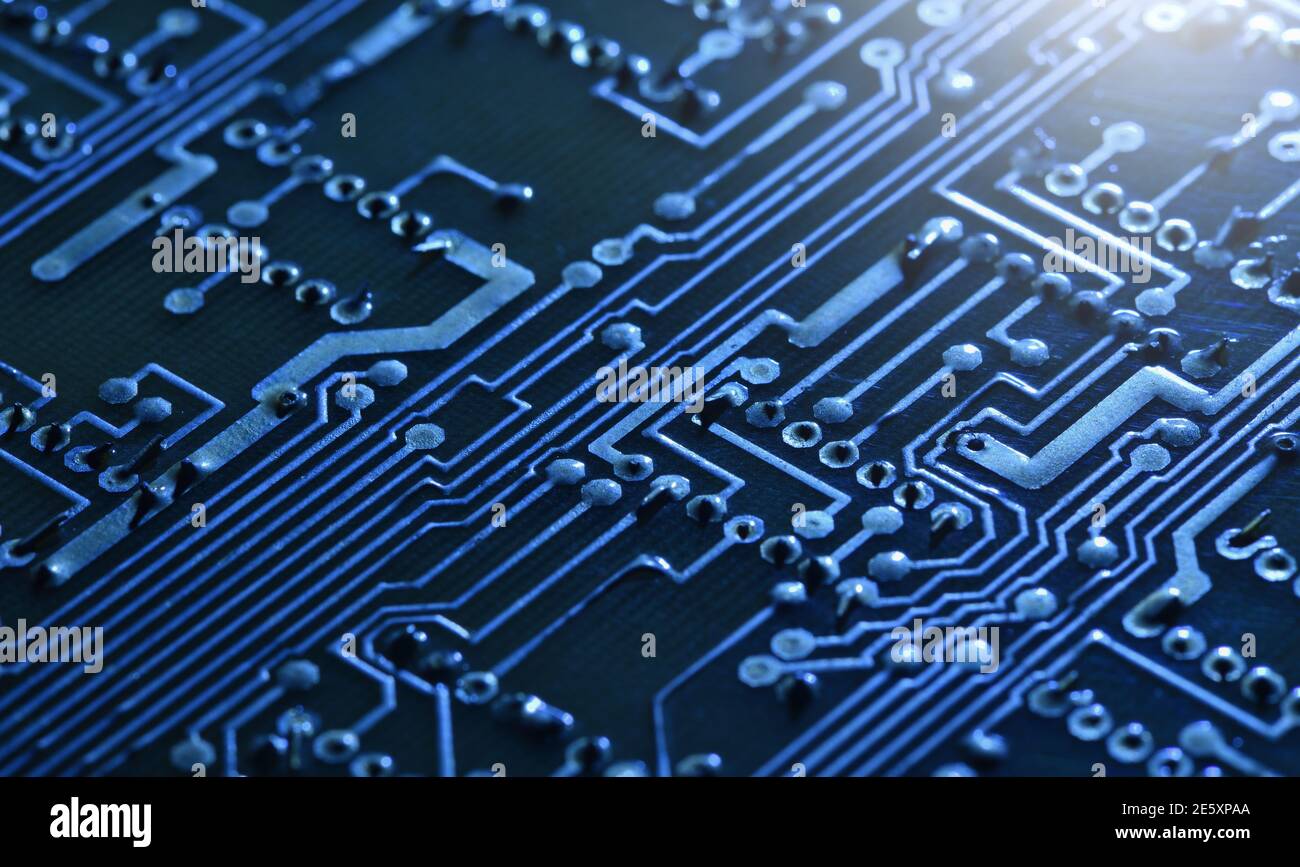 Elektronische Leiterplatte unter blauem Licht als Technologiehintergrund Stockfoto
