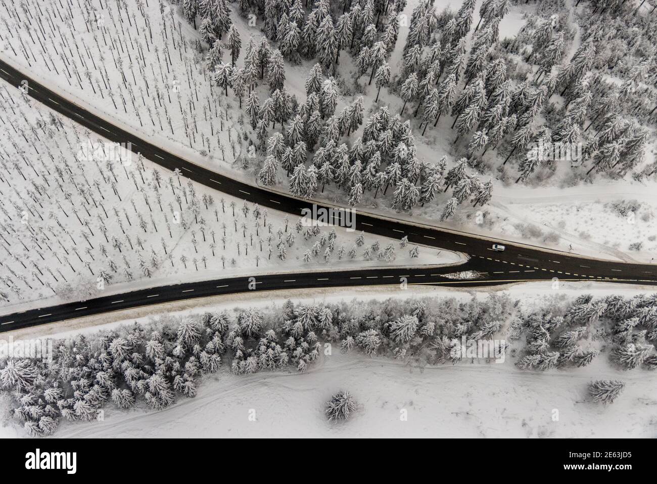 Luftaufnahme der verschneiten Winterlandschaft von Winterberg mit kurvenreichen Straßen und Wegen mit V-förmiger Straßengabel im Sauerland in Nordrhein-Westfalen, Deutschland Stockfoto