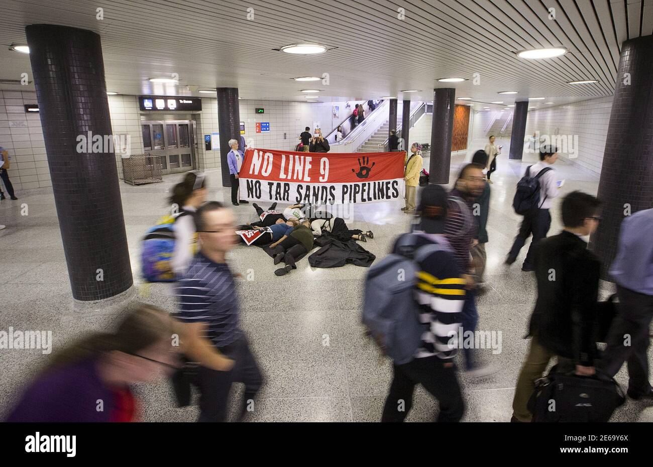 Demonstranten des "Toronto No Line 9 Network" führen einen "Einstand" durch, um zu demonstrieren, was sie sagen, die möglichen Auswirkungen wären, wenn die Enbridge die "Line 9"-Erdölleitung, die unter der Finch-U-Bahn-Station läuft, in Toronto am 29. Juni 2015 zerbrach. Enbridge hat die Erlaubnis gesucht, den Fluss der Pipeline, die vom südlichen Ontario nach Montreal verläuft, umzukehren. Das National Energy Board hat Enbridge beauftragt, hydrostatische Tests durchzuführen, bevor sie mit dem Plan fortfahren können, laut lokalen Medienberichten. REUTERS/Mark Blinch Stockfoto