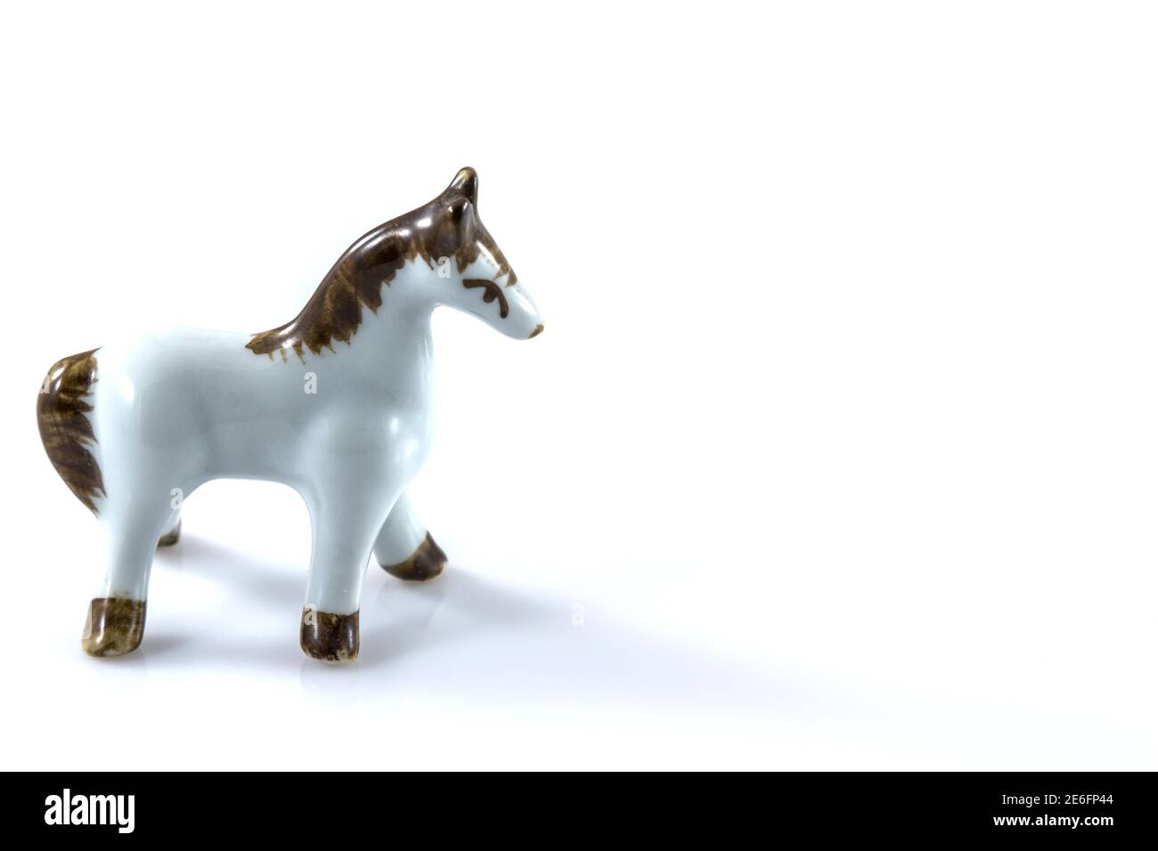 Weiße Keramikfigur eines Pferdes auf weißem Hintergrund Stockfoto