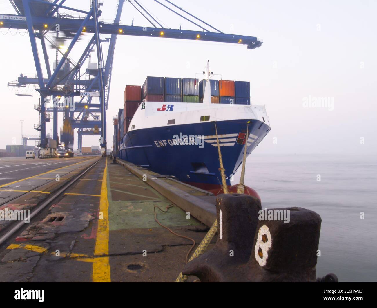 Containerschiff an den Felixstowe Docks wartet darauf, von geladen zu werden Ein Kran Stockfoto