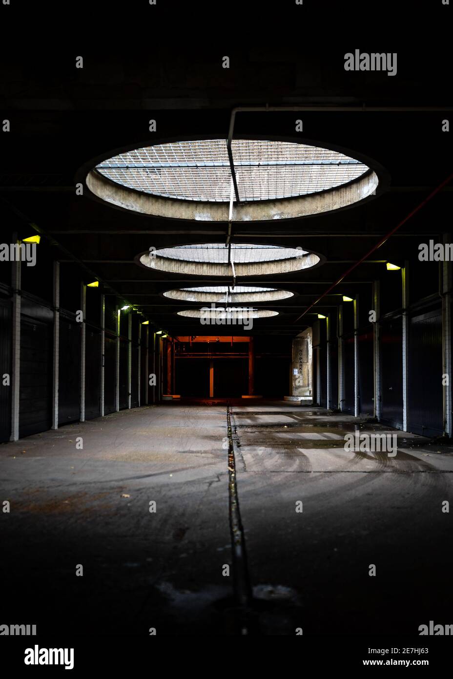 Unterirdisch dunkel launisch Beton gruselig Parkplatz Garagen runde Dachöffnungen Tag Lichtstrahlen durchscheinen schaffen futuristische Industrie Alien launisch Stockfoto