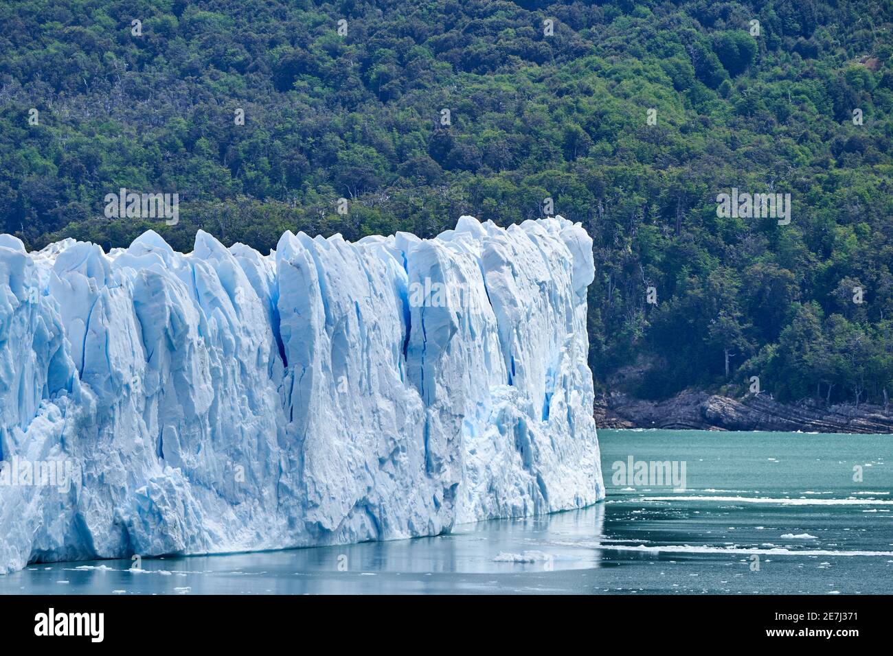 Blaues Eis des Perito Moreno Gletschers im Glaciers Nationalpark in Patagonien, Argentinien mit türkisfarbenem Wasser des Lago Argentino im Vordergrund und dunkel Stockfoto