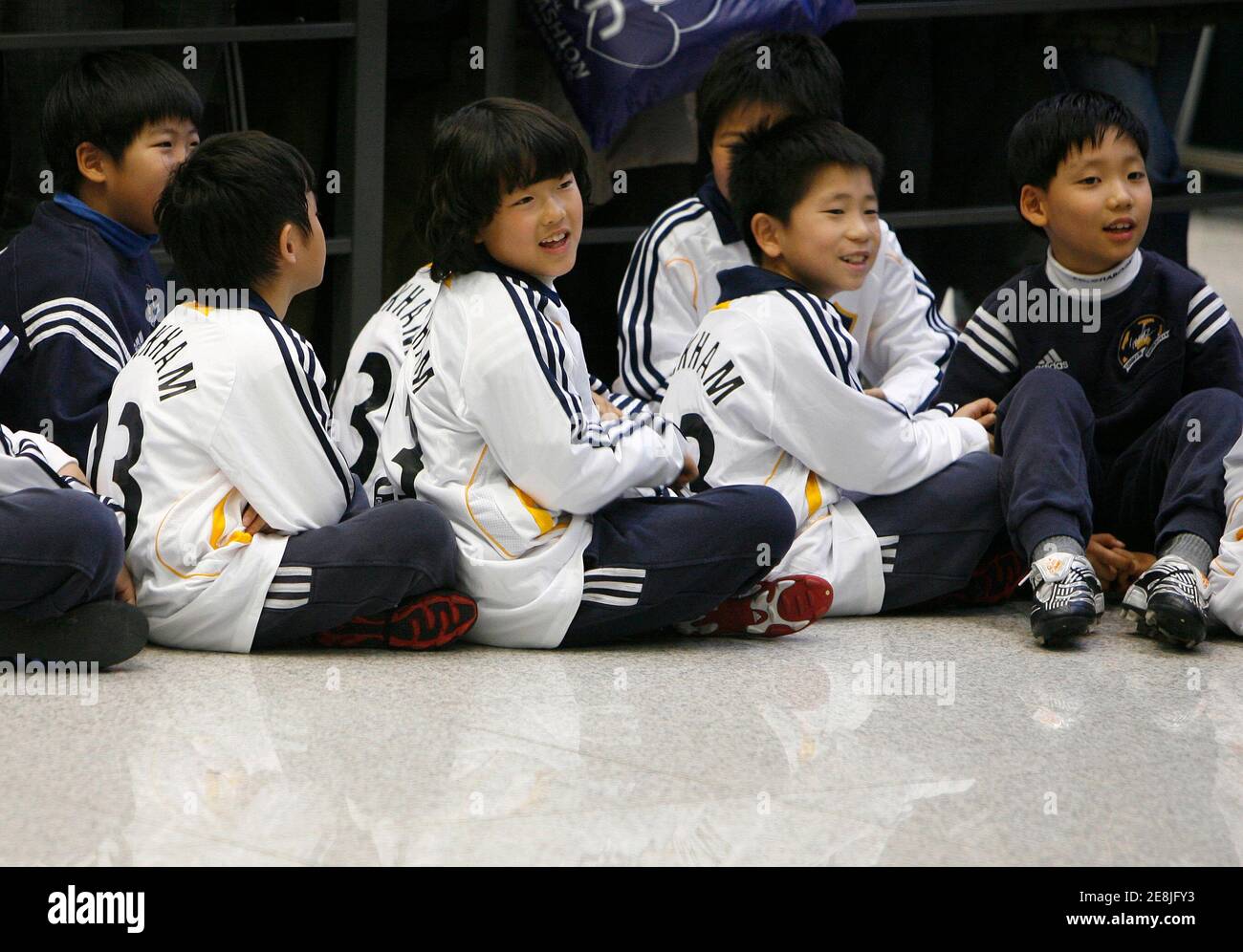 Los Angeles Galaxy Hemden mit Mittelfeldspieler Beckhams Namen darauf, Kinder warten auf seine Ankunft am internationalen Flughafen Incheon westlich von Seoul, 26. Februar 2008.    REUTERS/Jo Yong-Hak (Südkorea) Stockfoto