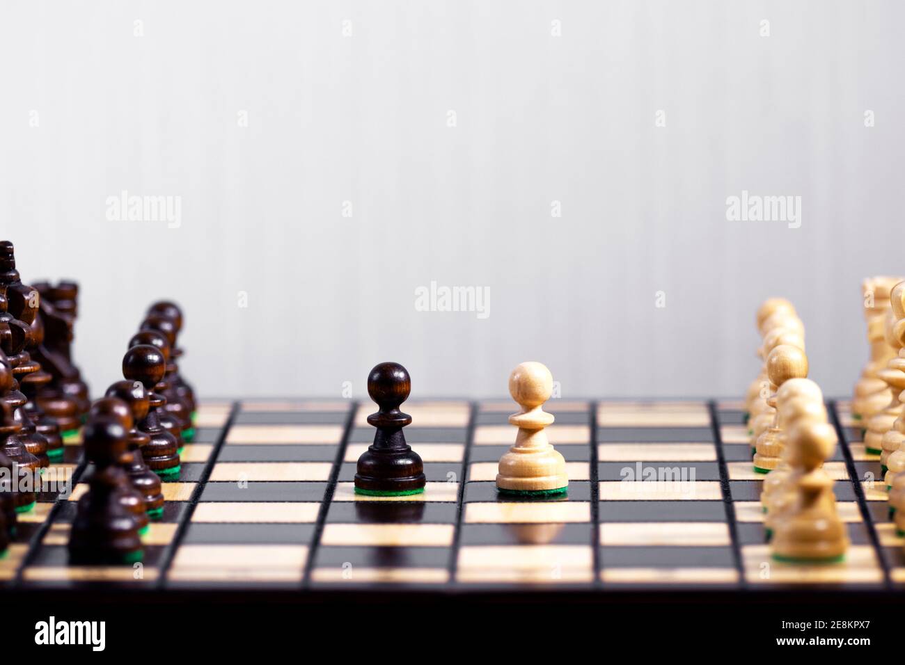 Zwei Schachfiguren nebeneinander stehend, der erste Schritt des Spiels, die Entscheidung treffen und eine Strategie treffen, Sieg in einem Schachspiel, Hobby das Stockfoto