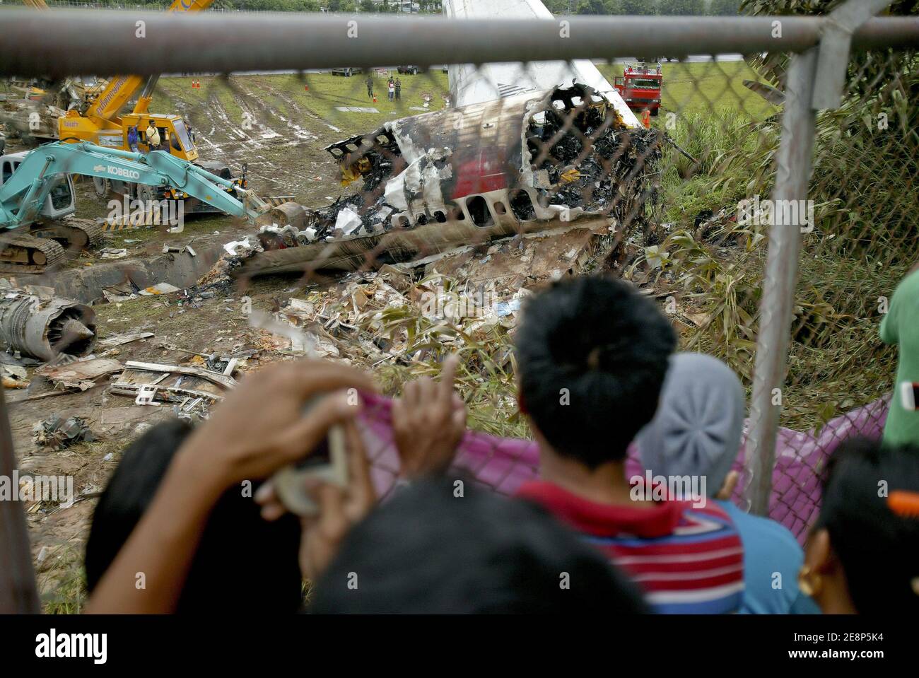 Rettungskräfte begutachten am 17. September 2007 den Flugzeugabsturz auf dem Flughafen von Phuket in Thailand.EIN Billigflugzeug mit 128 Personen an Bord stürzte am 16. September 2007 auf der thailändischen Ferieninsel Phuket ab. 88 Menschen wurden getötet, als es aufbrach und in Flammen aufging, während er versuchte, bei starkem Regen zu landen.die restlichen 42 Menschen an Bord des Fluges aus Bangkok überlebten und wurden in nahe gelegenen Krankenhäusern wegen einer Vielzahl von Verletzungen behandelt. Foto von Patrick Durand/ABACAPRESS.COM Stockfoto