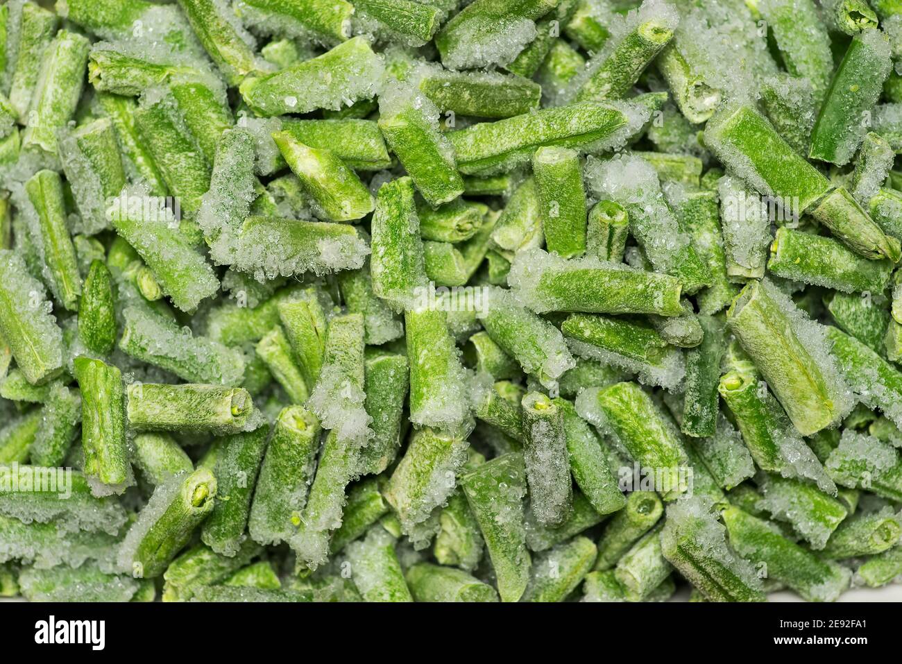 Gefrorene grüne Bohnen Gemüse, die ein Hintergrundmuster Stockfoto