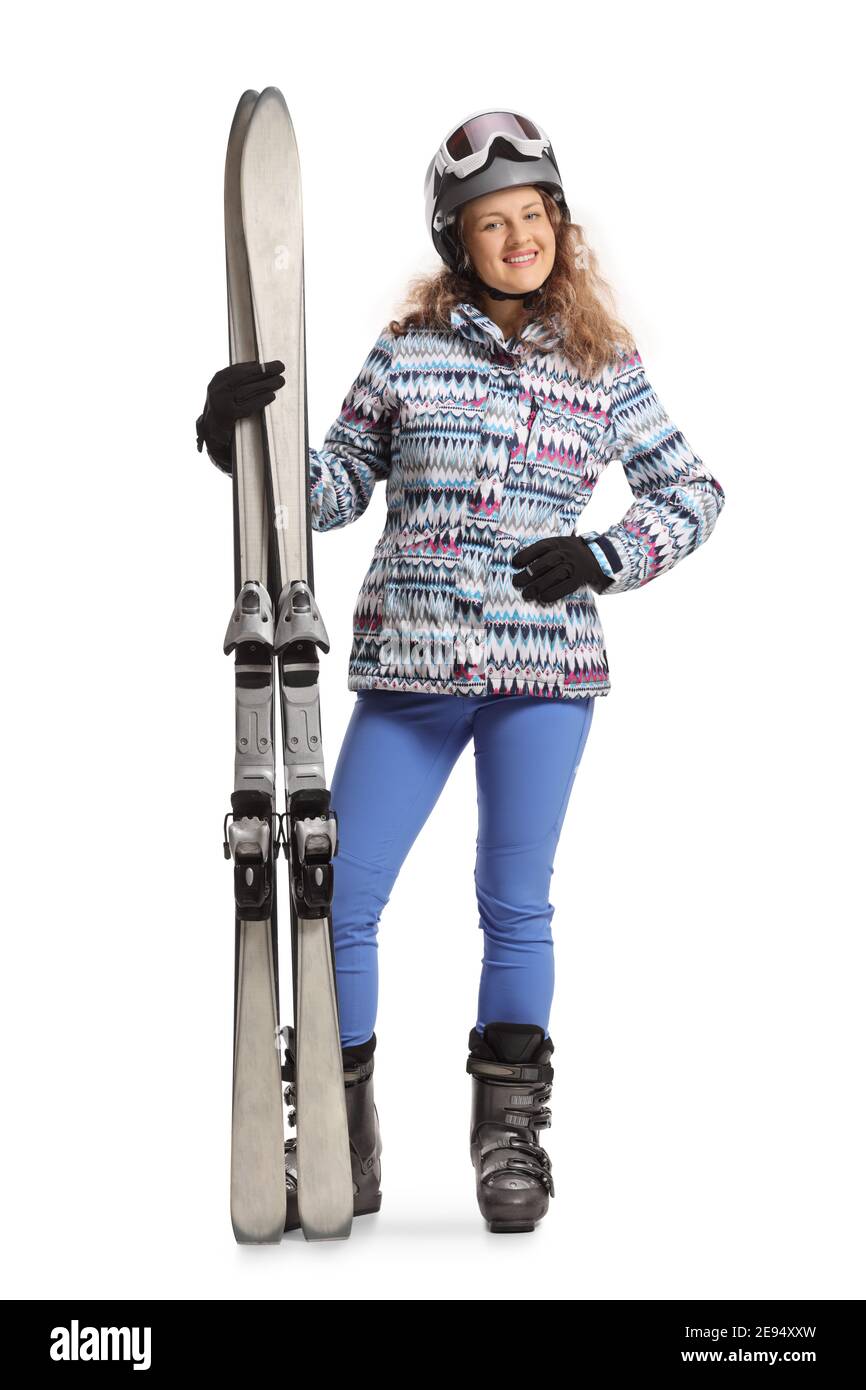 Ganzkörperportrait einer jungen Frau in einem Ski Uniform lächelnd und Blick auf die Kamera isoliert auf ein Weißer Hintergrund Stockfoto